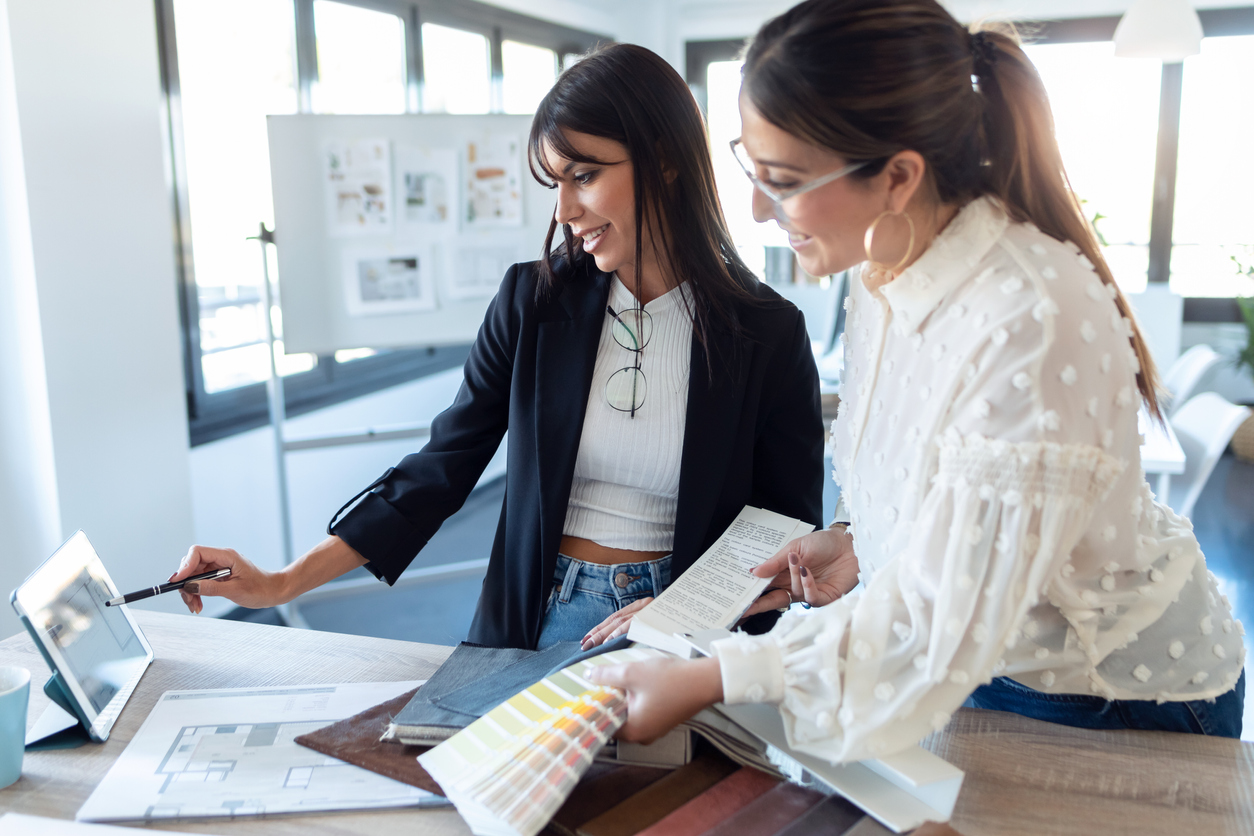 Two women choosing materials for a design project