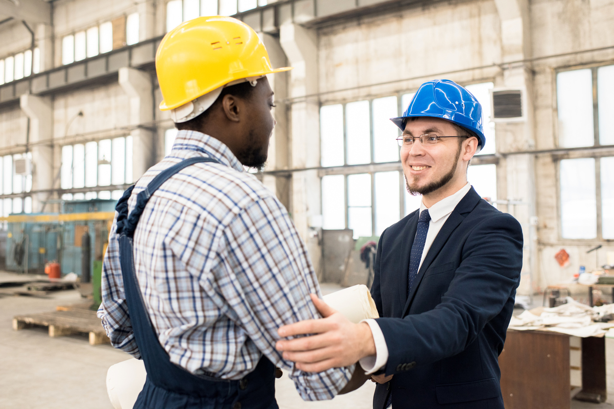 Construction manager shaking hand of foreman