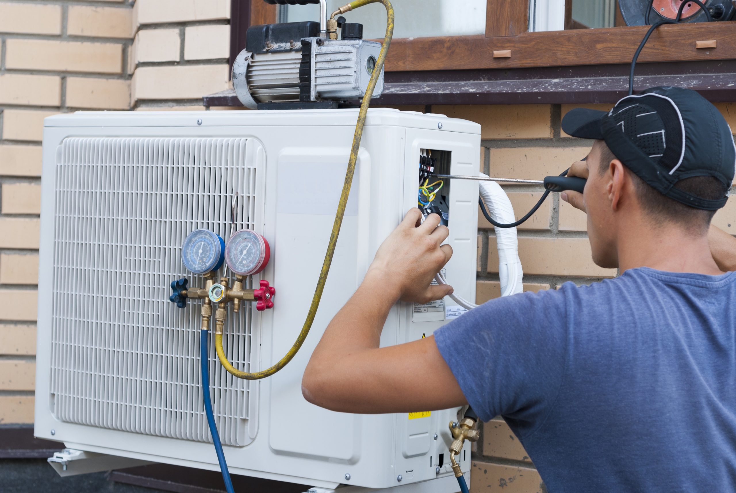 Technician working on air conditioner