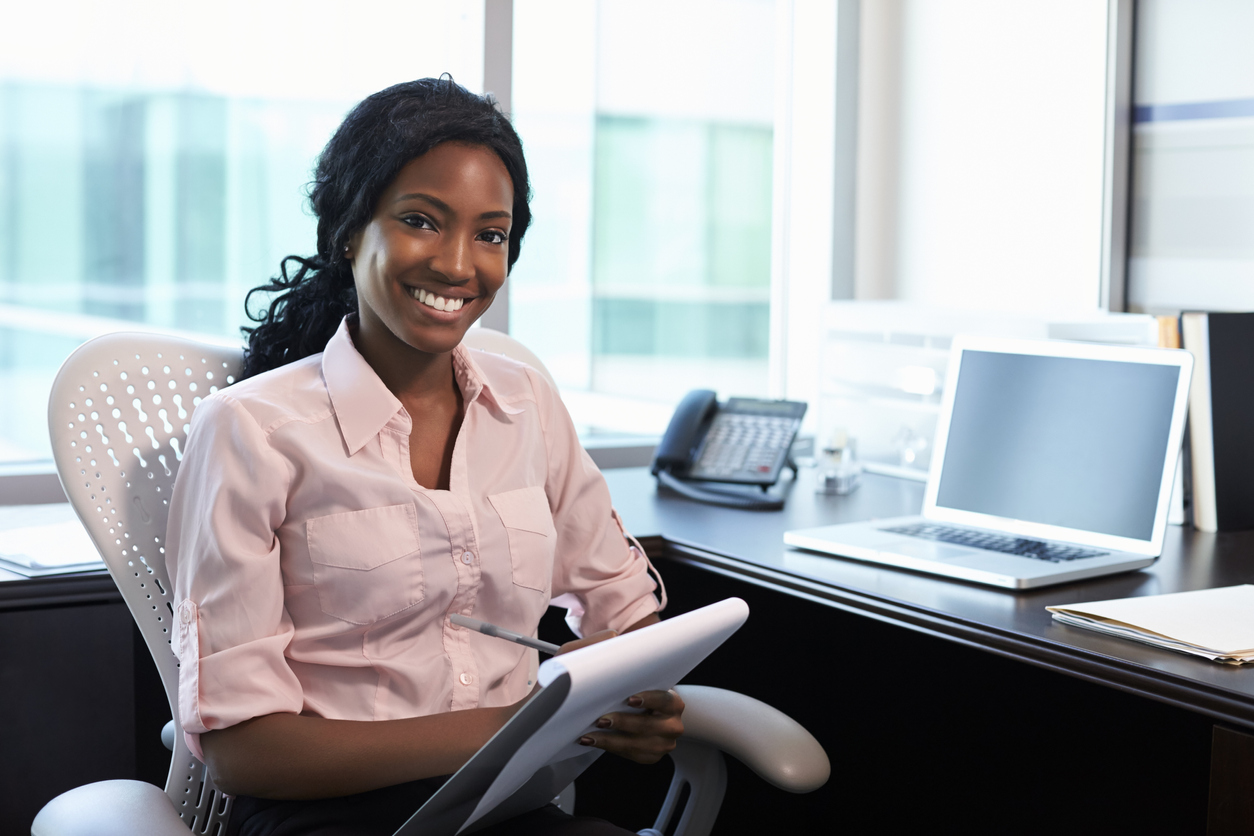 Smiling woman sitting at desk in office